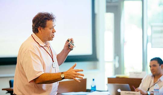 Professor George Foster speaking in a classroom | Stanford Graduate School of Business