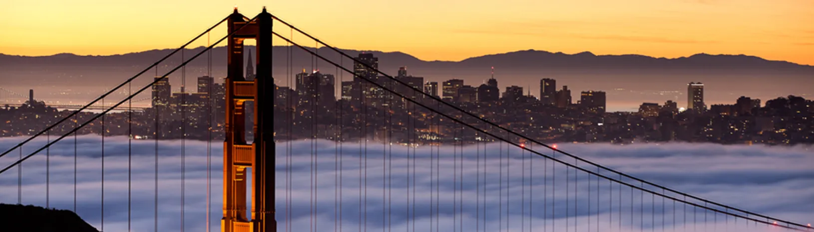 Golden Gate Bridge in fog at sunset