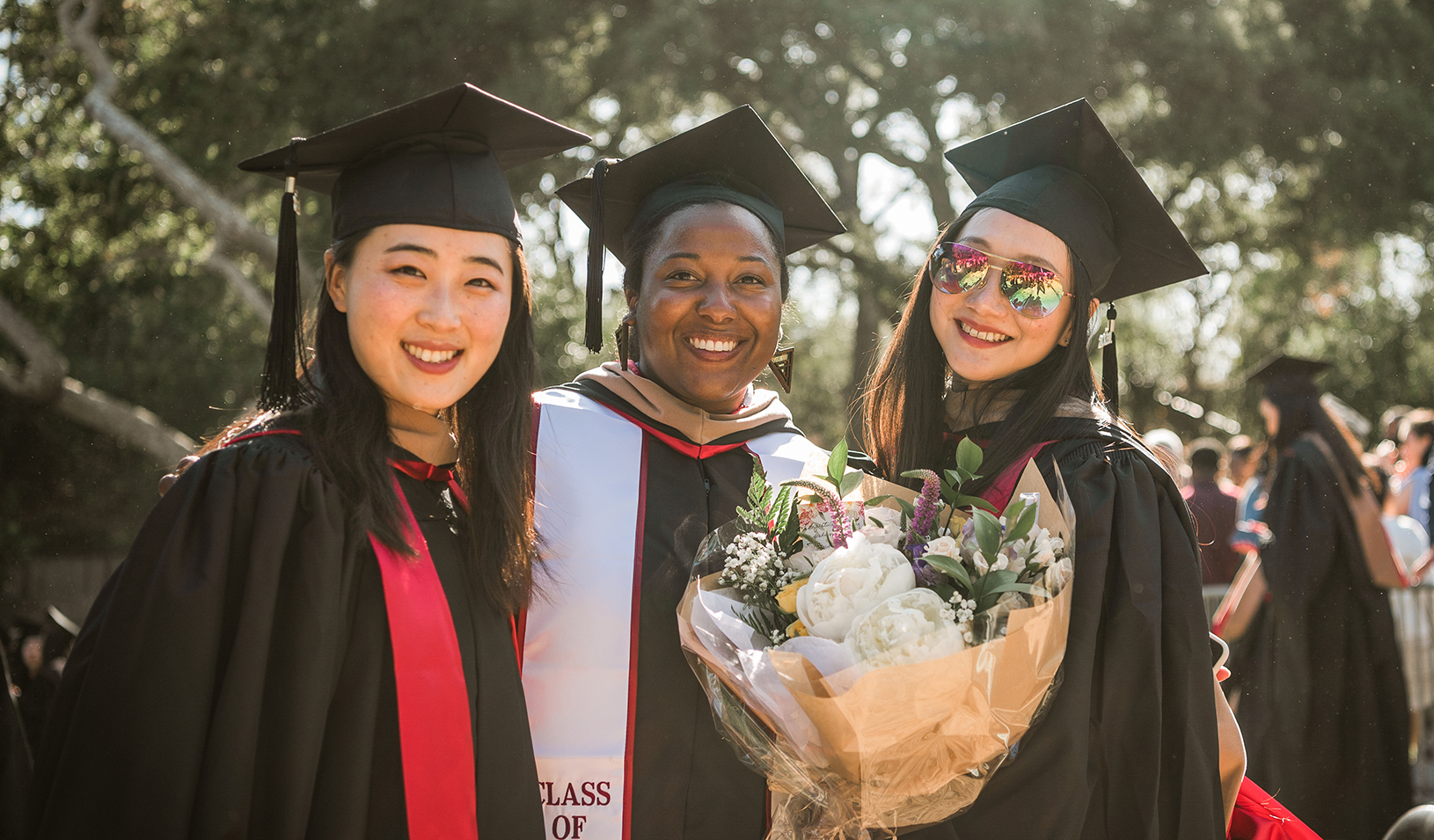 Three students at the graduation celebration. Credit: Photo by Best Grad Photo Inc.