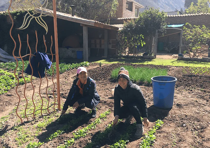 Kiki Davis and another woman working in a garden in Peru. Credit: Courtesy of Kiki Davis
