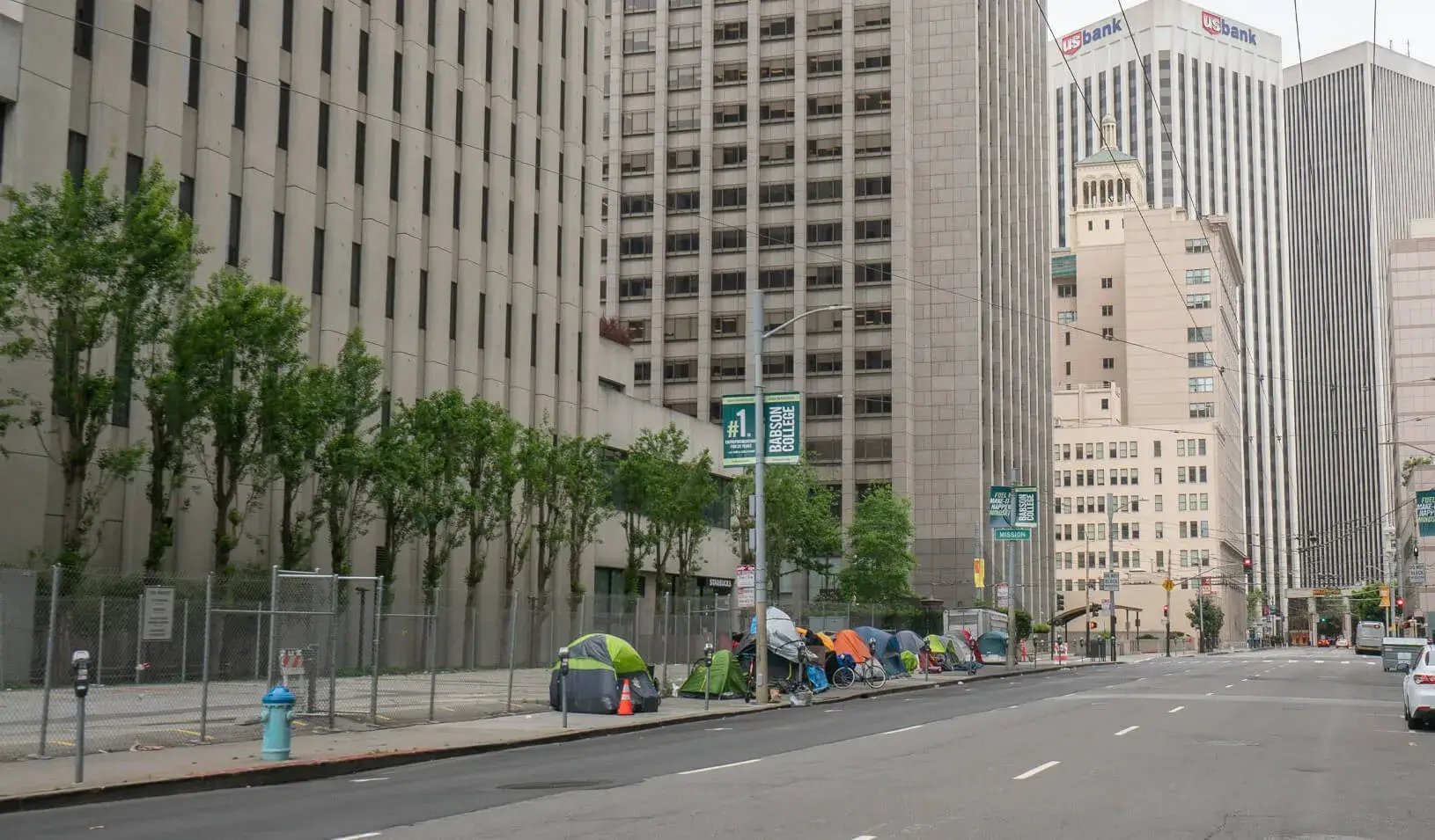 Homeless tents line Main Street in San Francisco's financial district during shelter-in-place order. Tents are surrounded by modern skyscrapers in an affluent area of the city. Credit: iStock/DianeBentleyRaymond