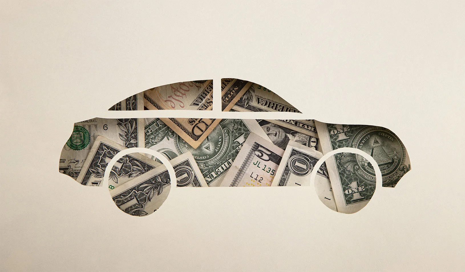 a car shape cut out of paper with money showing through from behind.
