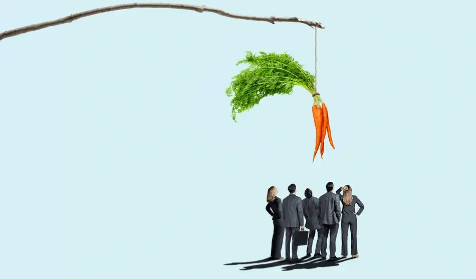 A group of businesspeople stand together looking up at a dangling carrot. Credit: iStock/DNY59, Tricia Seibold