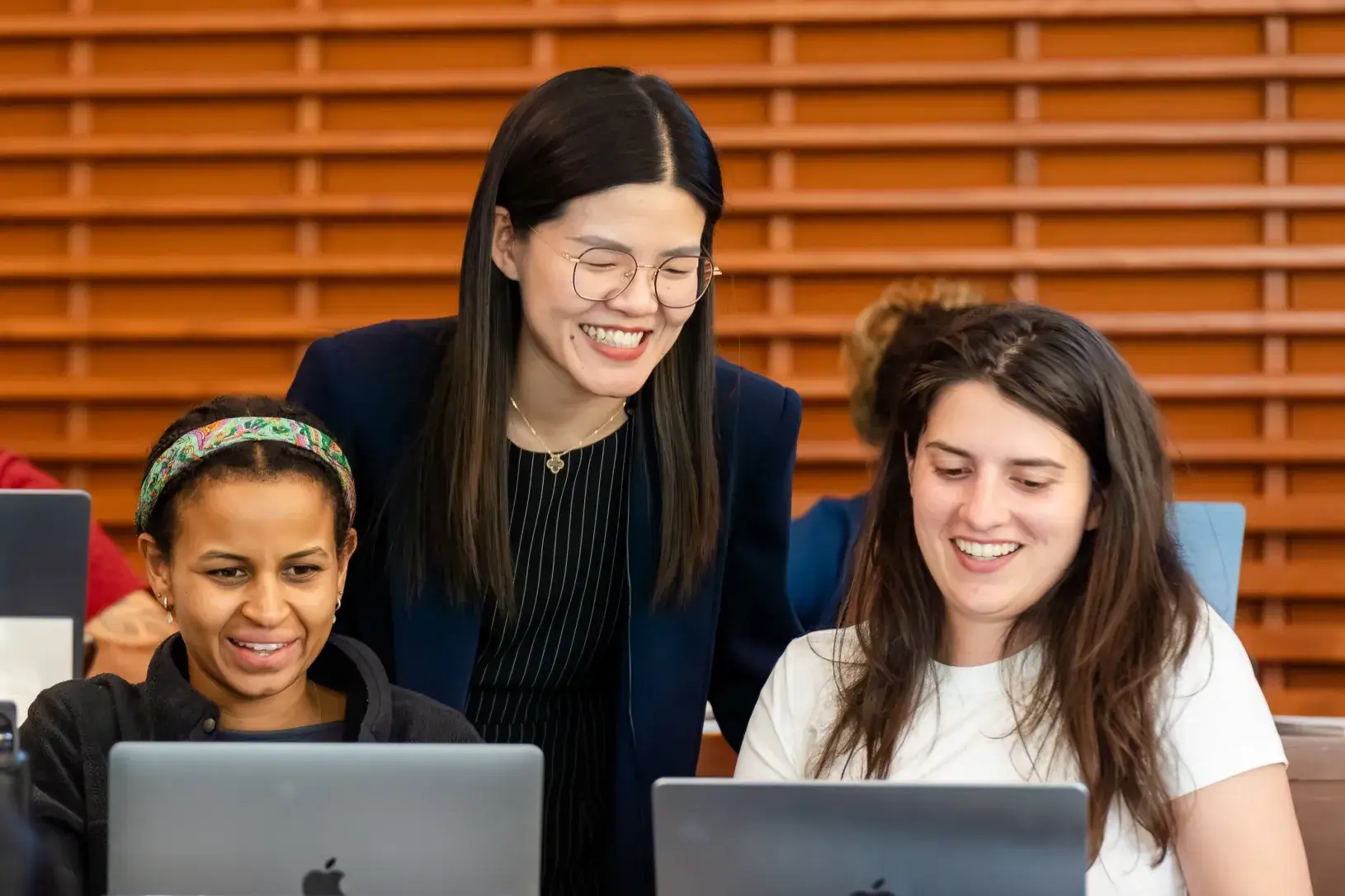 MBA students interacting with professor 