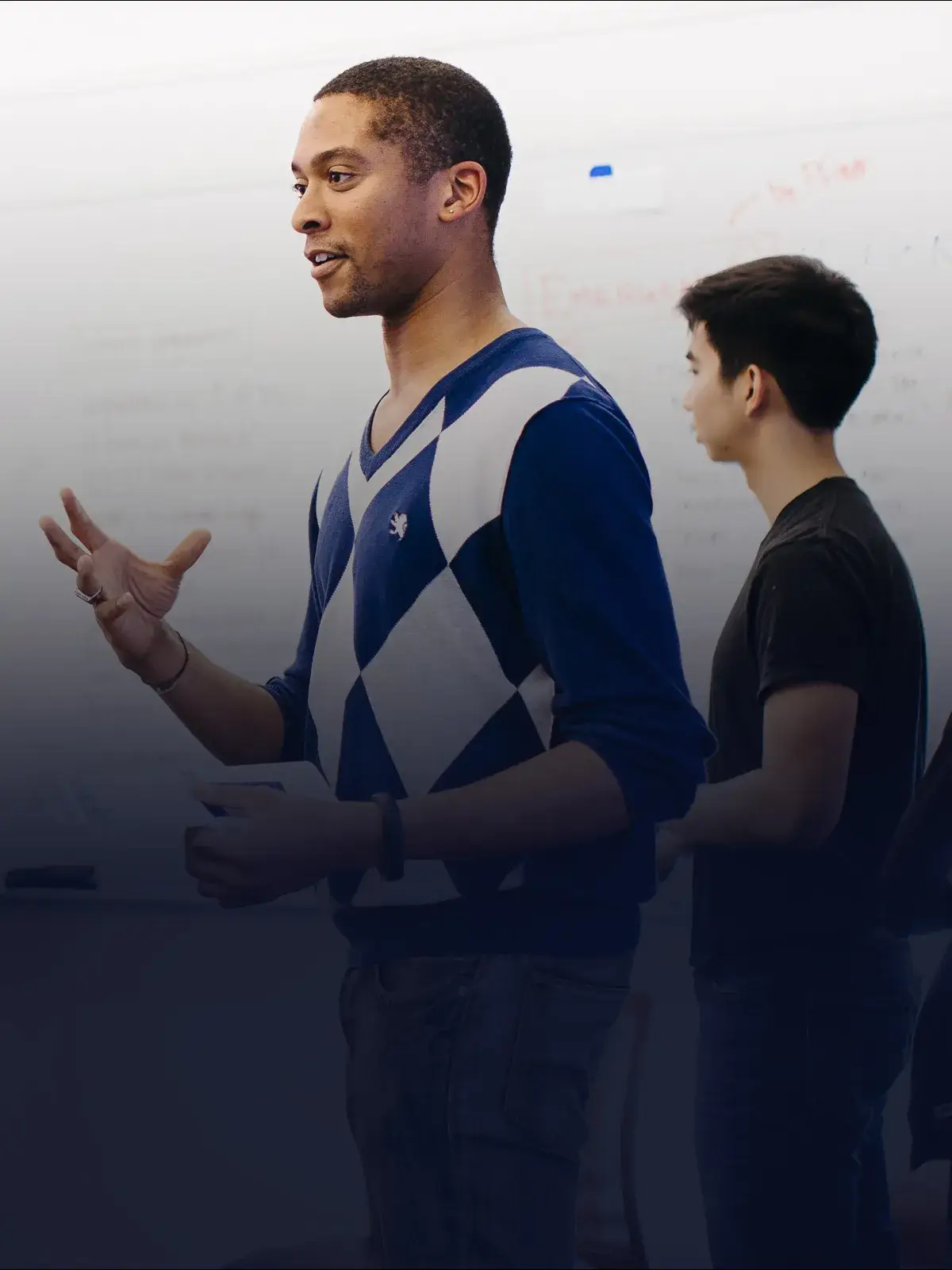 Student speaking with Dean Soule in a classroom on the GSB campus
