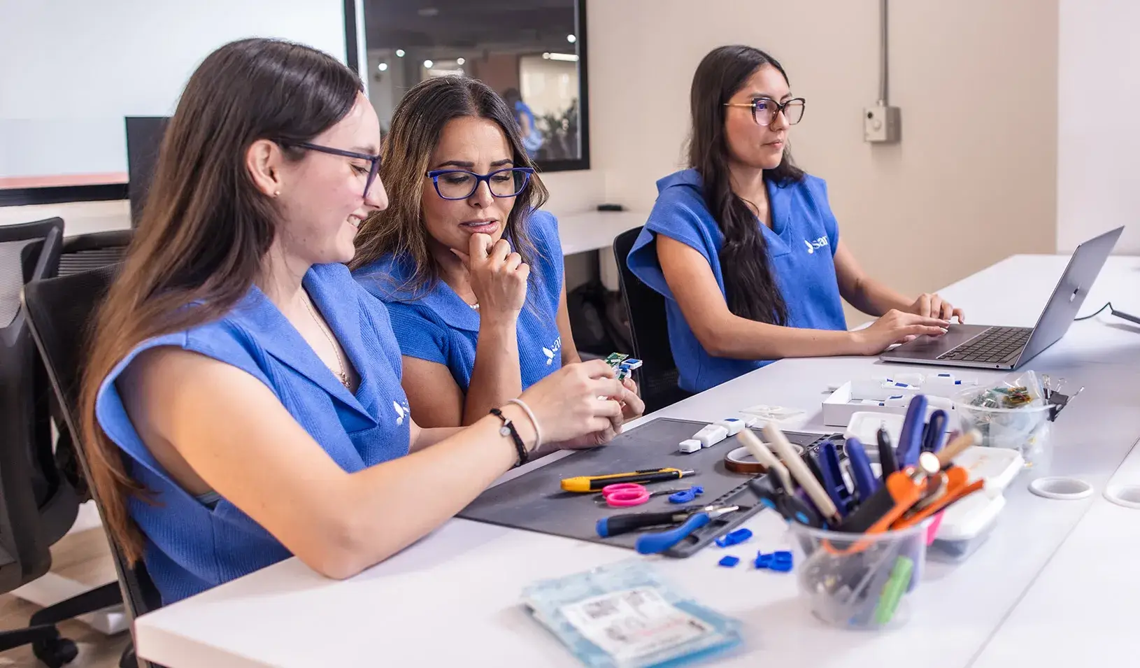 Med tech staff look at a computer