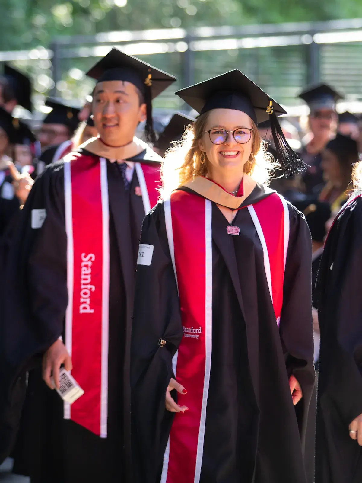 Grads in caps and gowns on campus at GSB