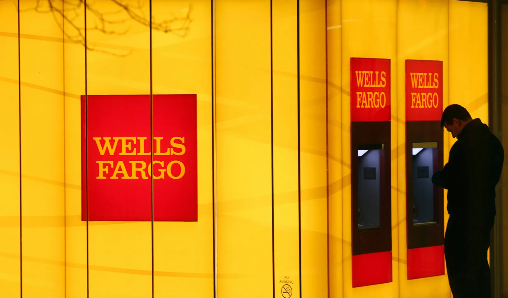 A man uses an automated teller machine. (Reuters photo by Gary Cameron)