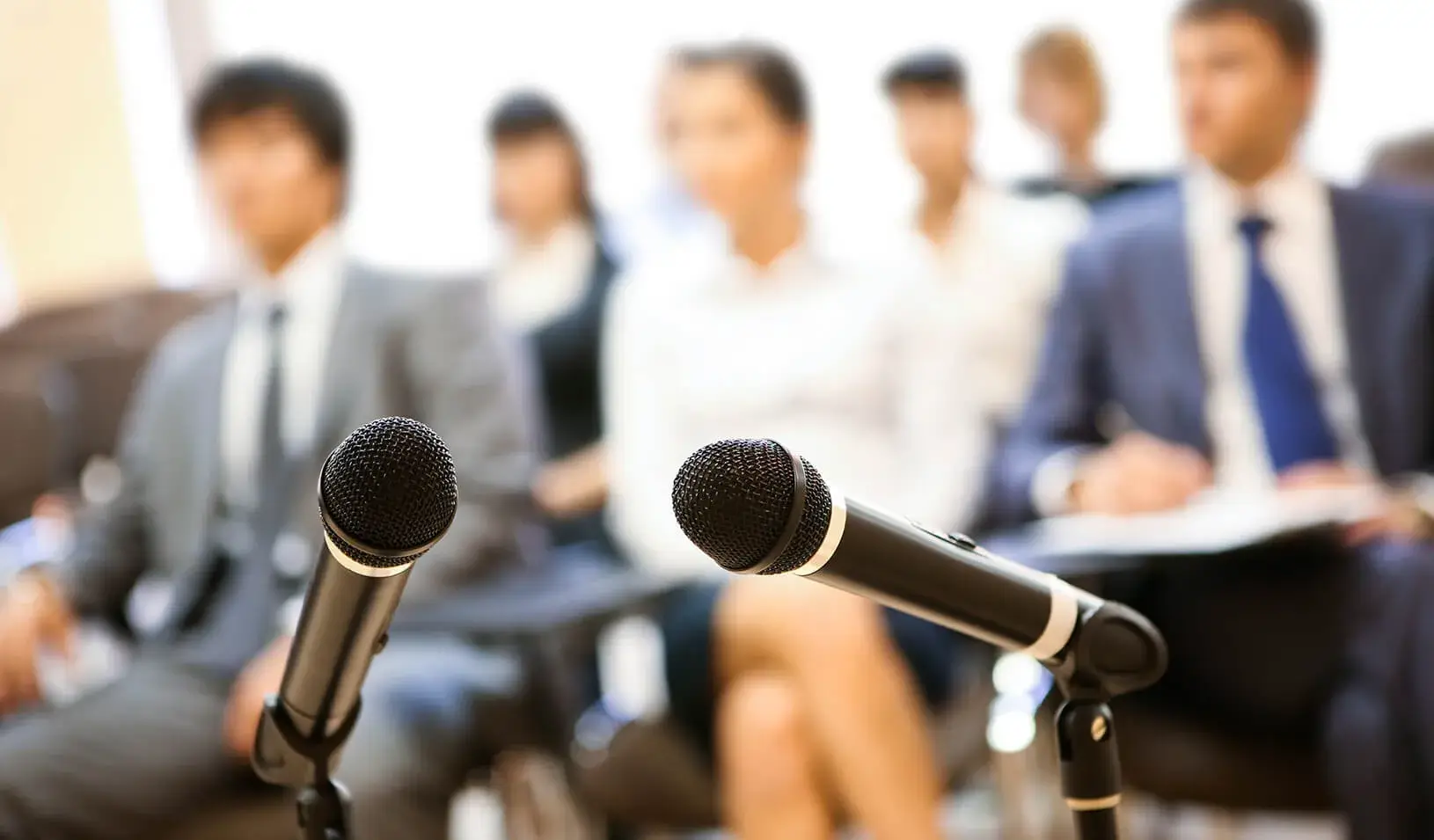 microphones in front of an audience