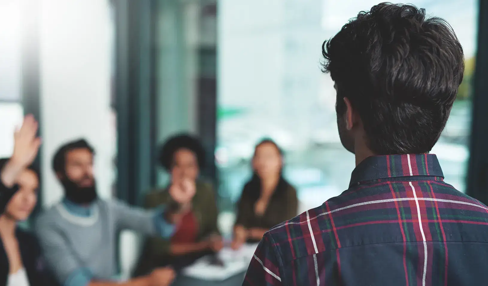 People asking questions of a presenter. Credit: iStock/PeopleImages