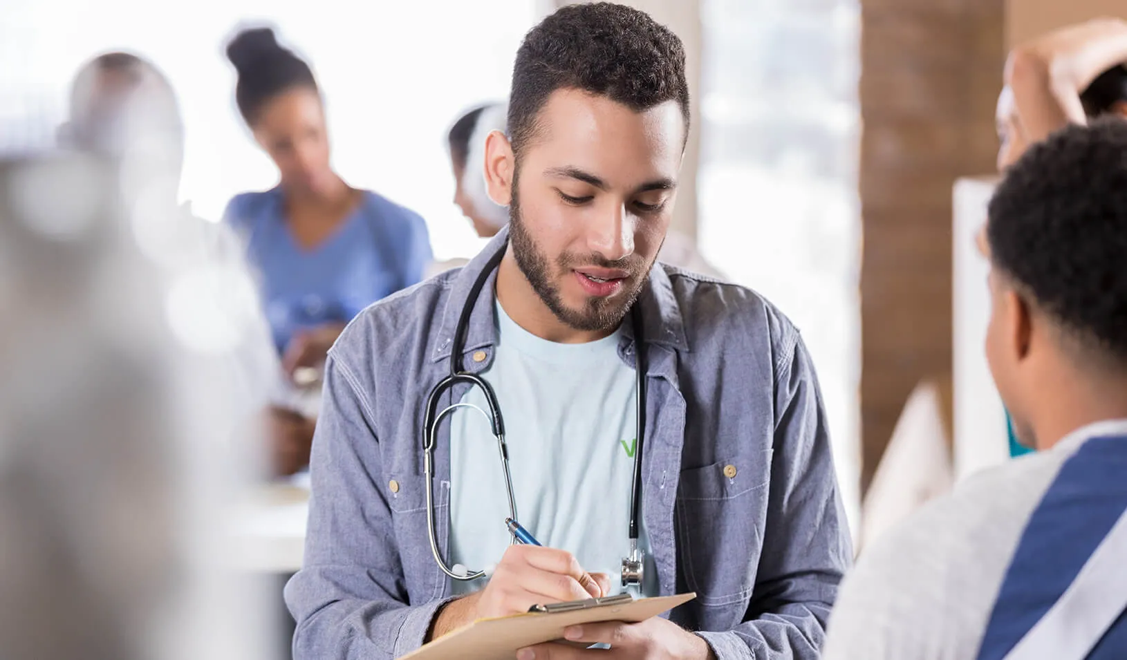 A young doctor performing a wellness check. Credit: iStock/asiseeit