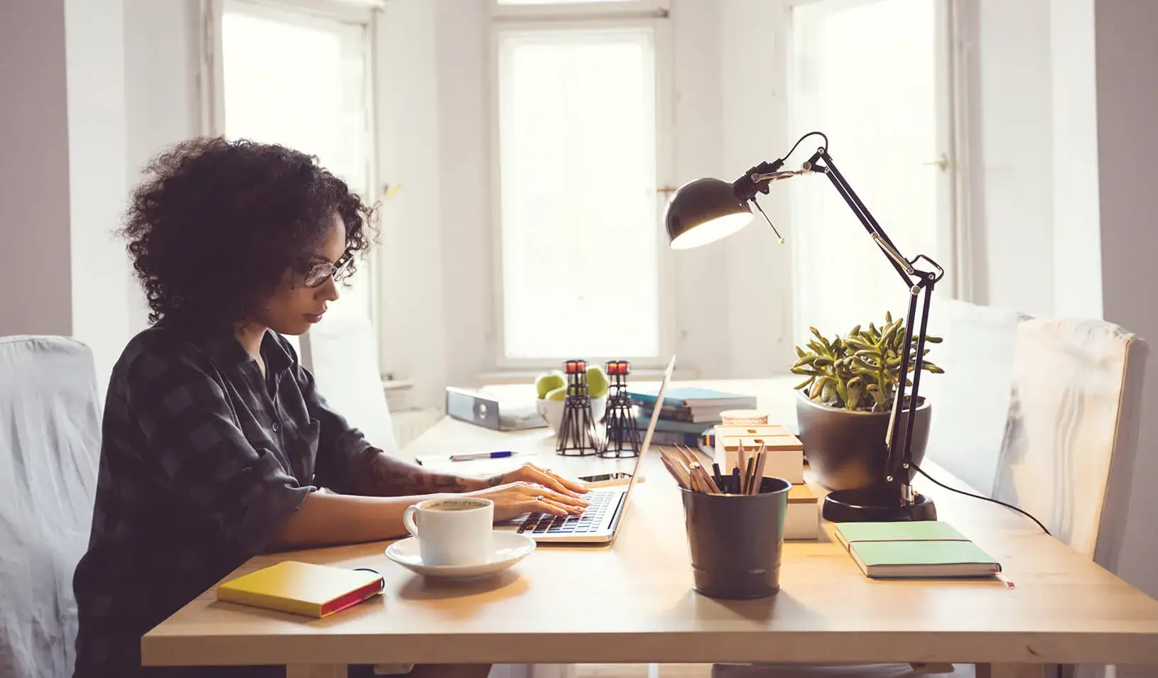 A young woman works at her home office. | iStock/Izabela Habur 