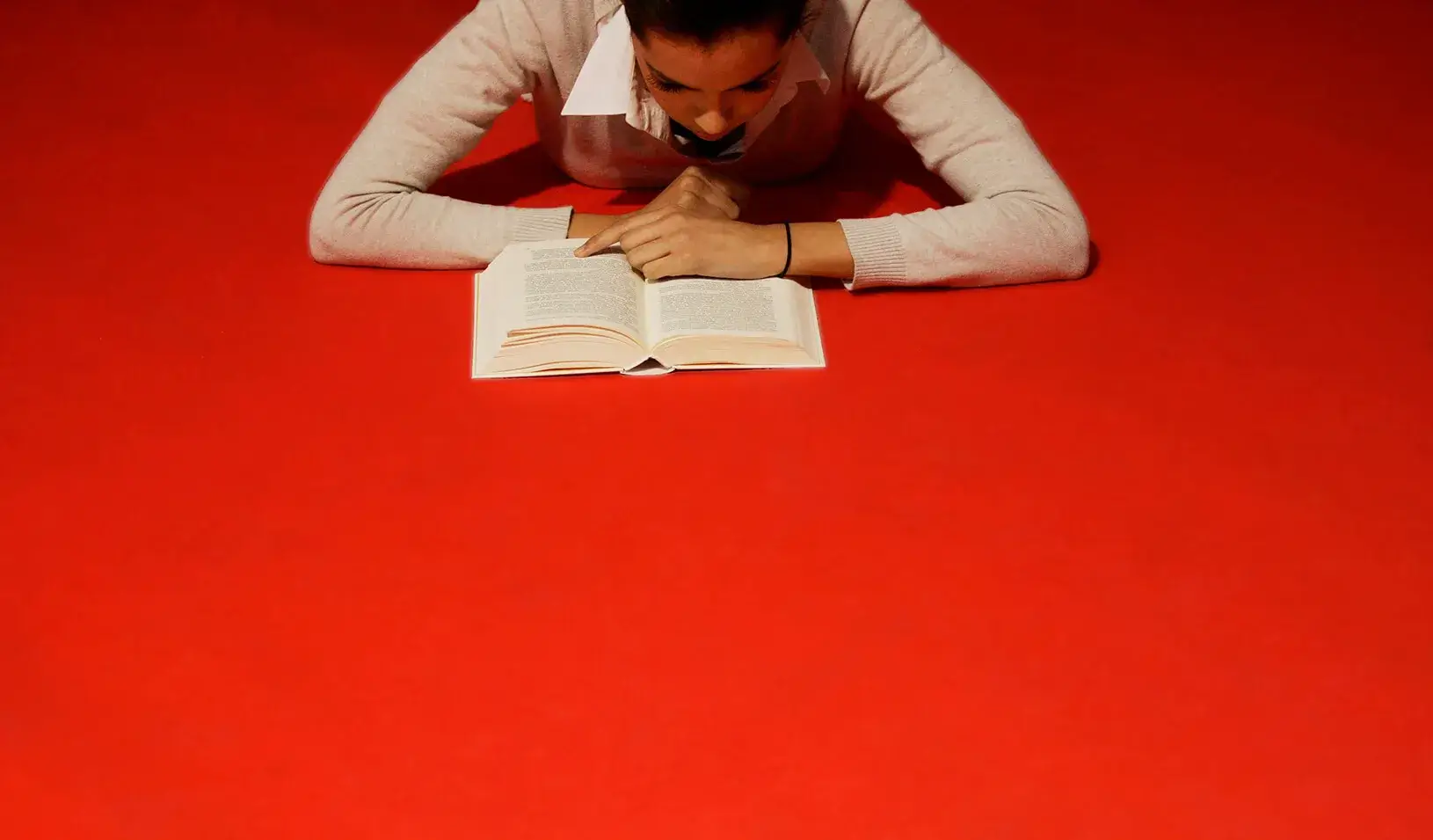 A woman reads a book | Reuters/Miguel Vidal