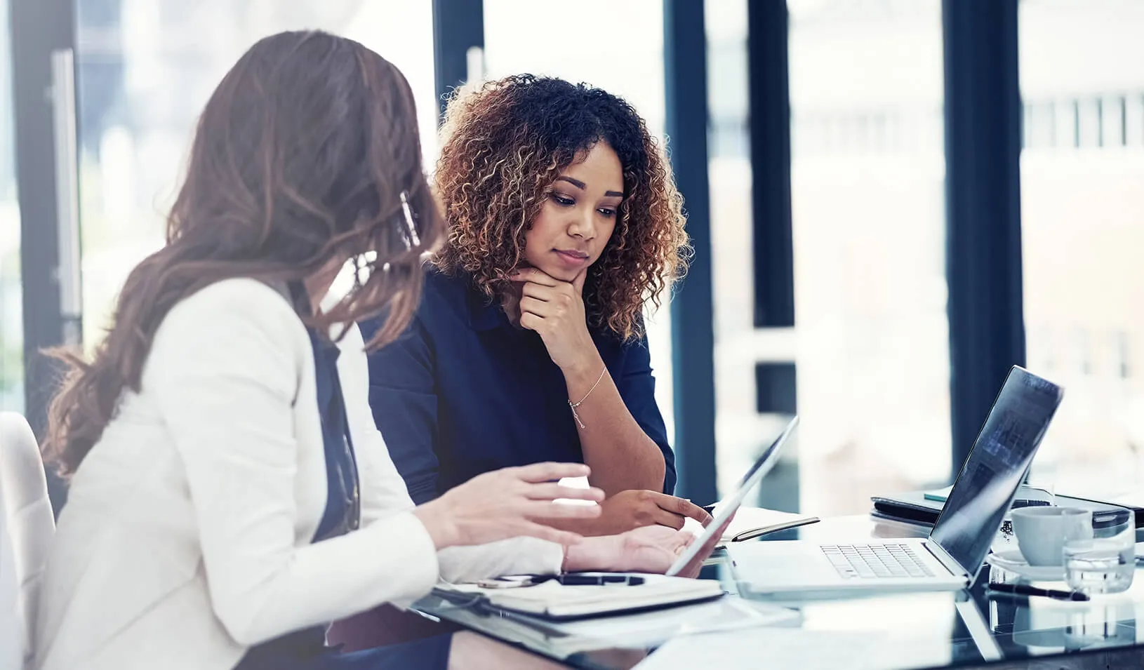 Two women at work. | iStock/Tinpixels