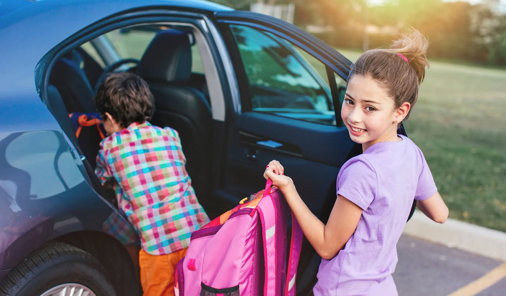 Kids getting into a car | iStock/kate_sept2004