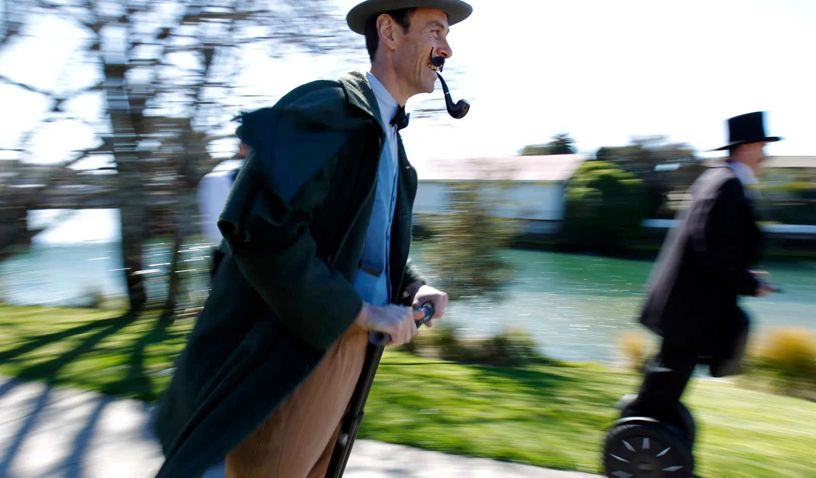 Men in traditional clothing ride on Segways after the re-enactment of the first match rugby ever played in New Zealand, 2011. (Reuters photo by Marcos Brindicci)