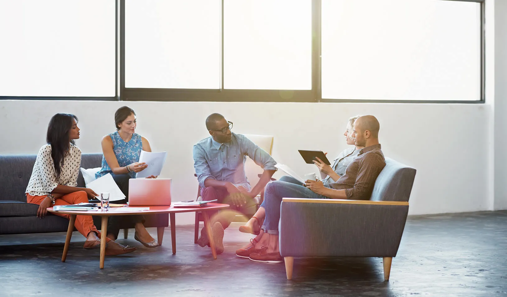 A group of coworkers collaborate on a project. | iStock/kupicoo