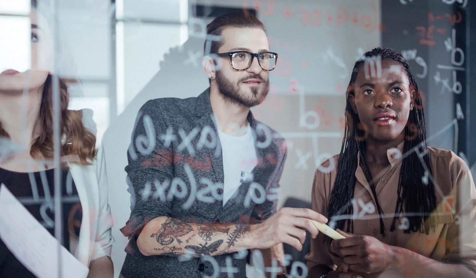 A team works together to solve a problem. Credit: iStock/Anchly