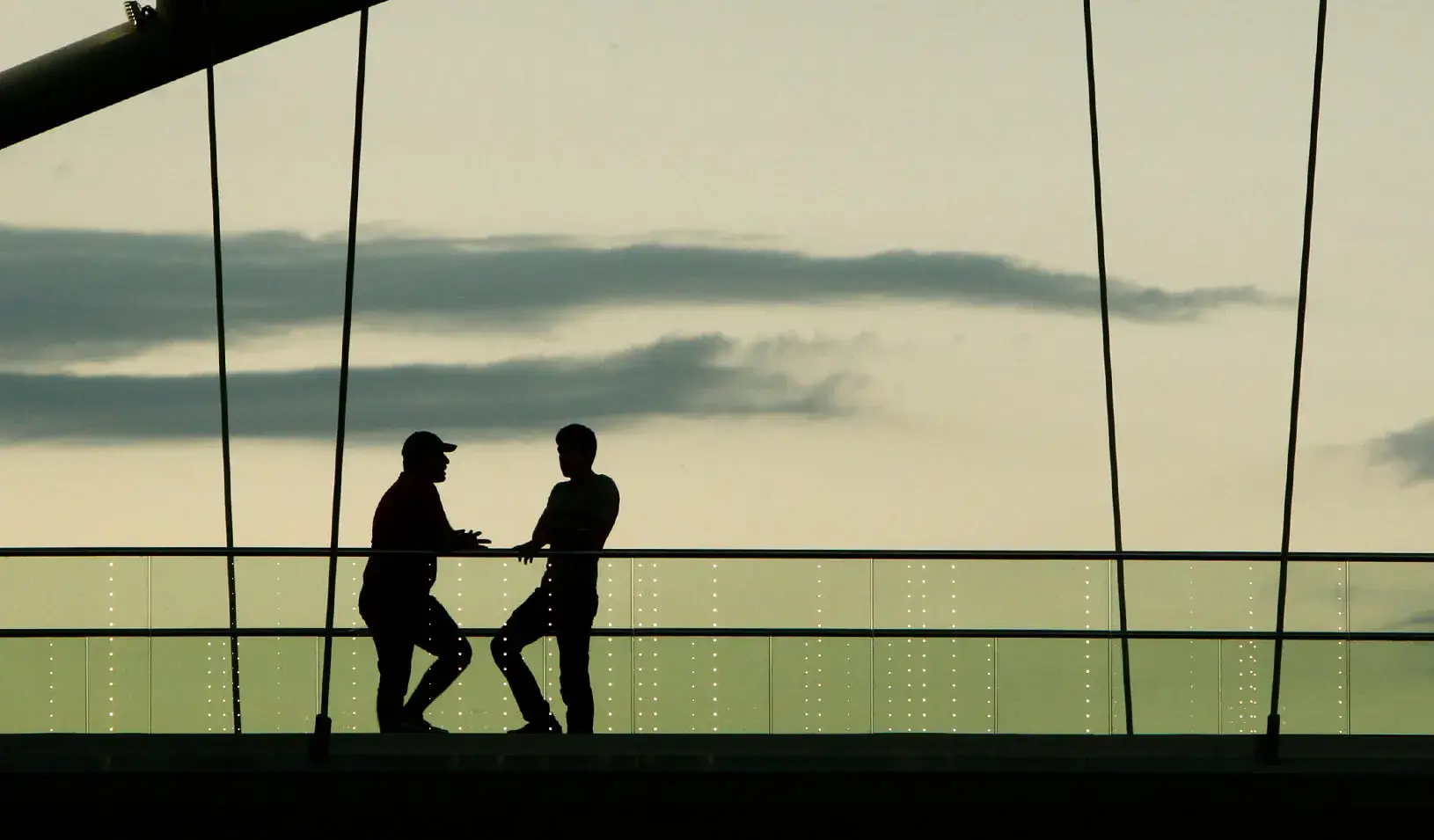 Two men chat on a footbridge. Credit: Reuters/David Mdzinarishvili