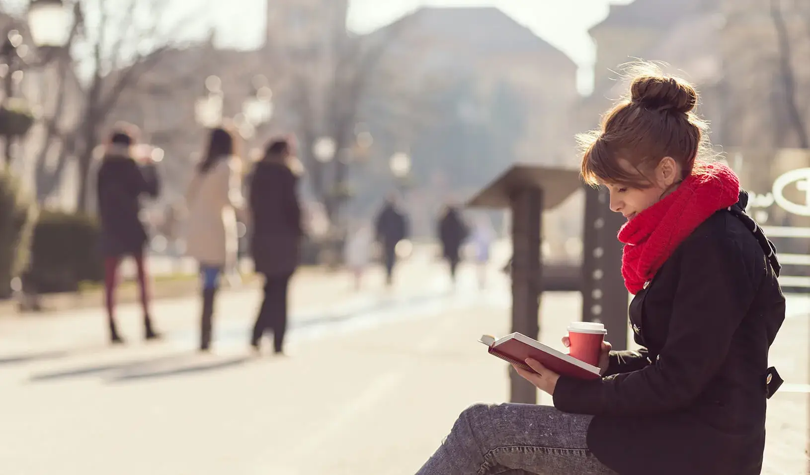 A girl reading a book | iStock/Vladins