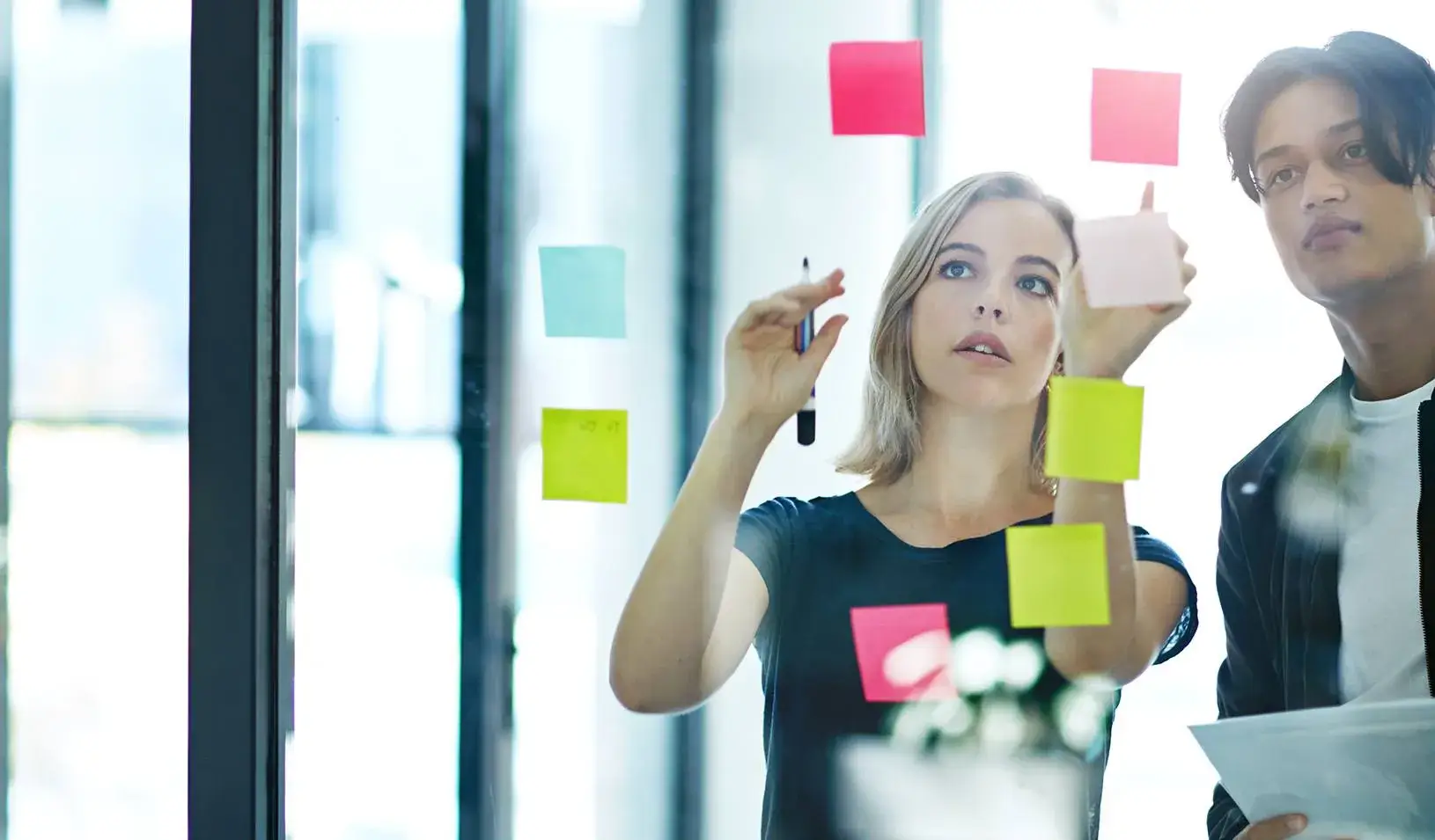Shot of two colleagues having a brainstorming session in a modern office. Credit: iStock/laflor