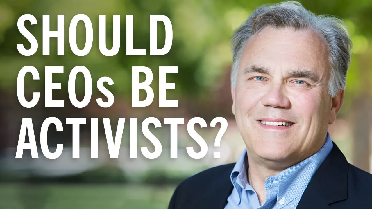 David Larker, The James Irvin Miller Professor of Accounting at Stanford GSB, smiling outdoors in front of a green background. Credit: Nancy Rothstein.