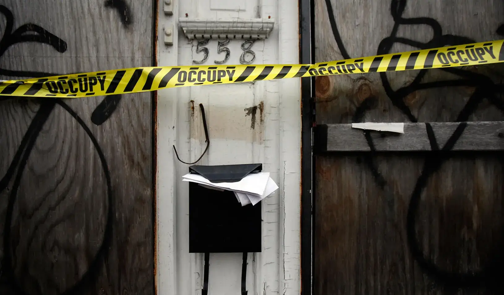 The door of an abandoned house with caution tape in front of it. | Reuters/Mike Segar