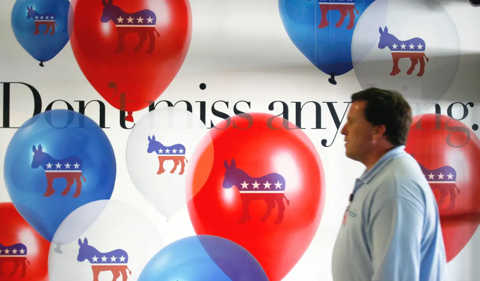 Man walking by an advertisement for the 2012 Democratic National Convention