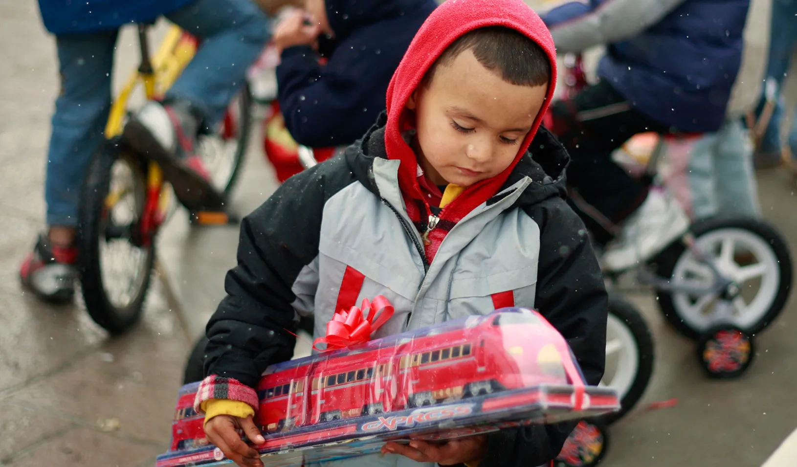 A boy holds a toy train