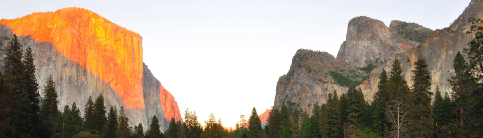 Half dome at Yosemite National Park bathed in orange sunlight