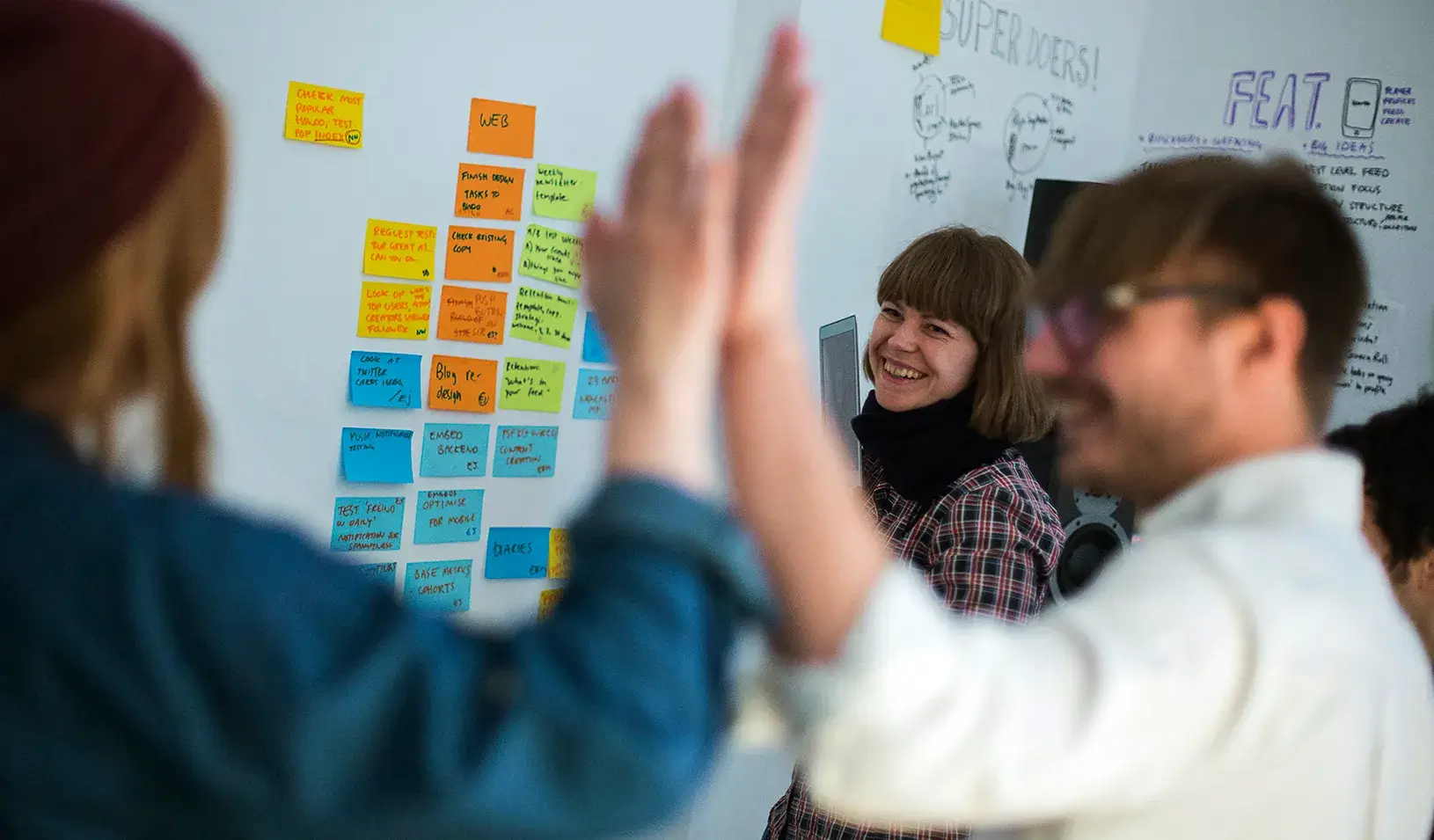 People giving a high-five in a work meeting