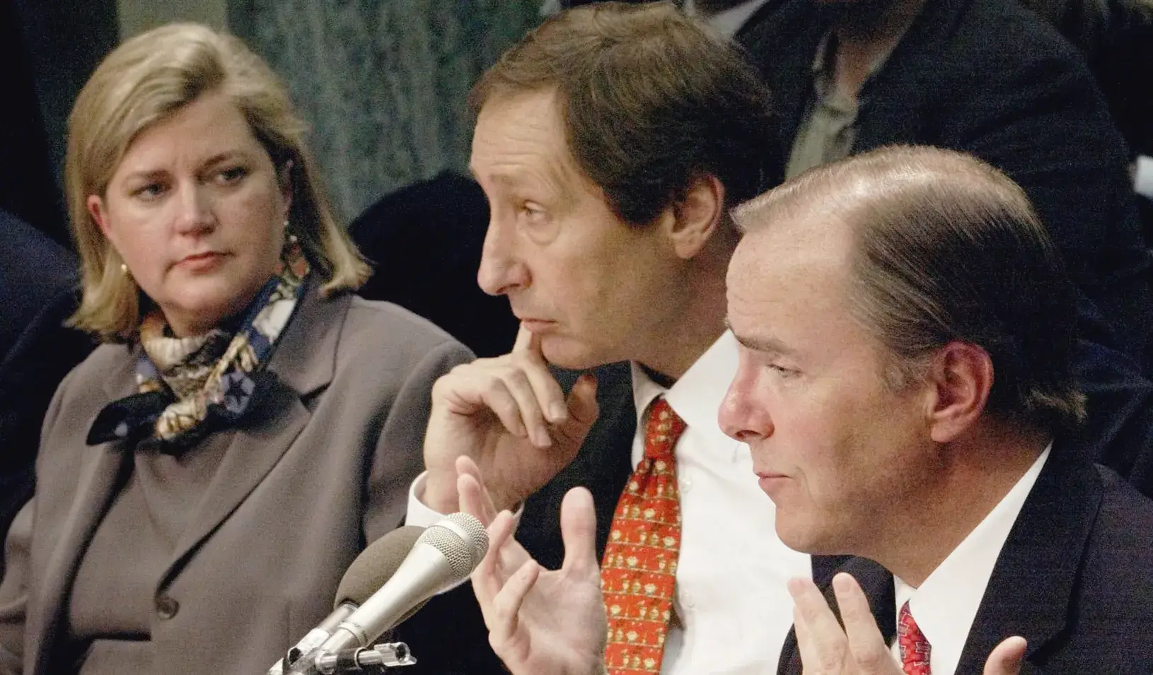Enron executive Sherron Watkins, left, who objected to a type of fair-value accounting used by the company, looks on in 2002 as former Enron CEO Jeffrey Skilling testifies on Capitol Hill.