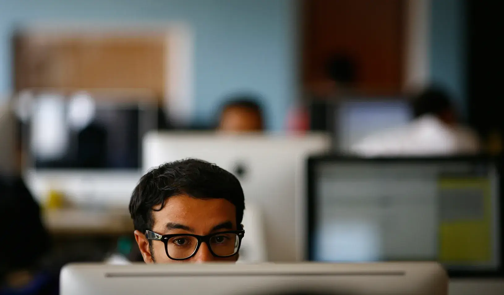 Man sitting at his computer. | Reuters/Navesh Chitrakar
