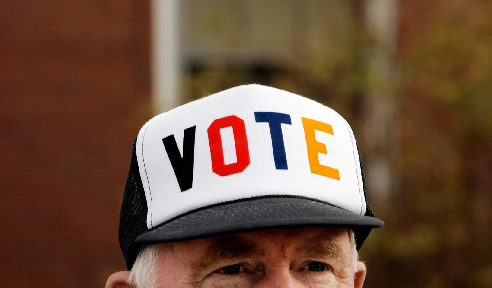 Man with a hat that reads "Vote"