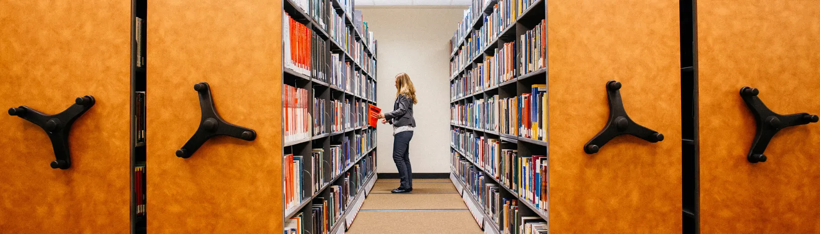 woman in library stacks