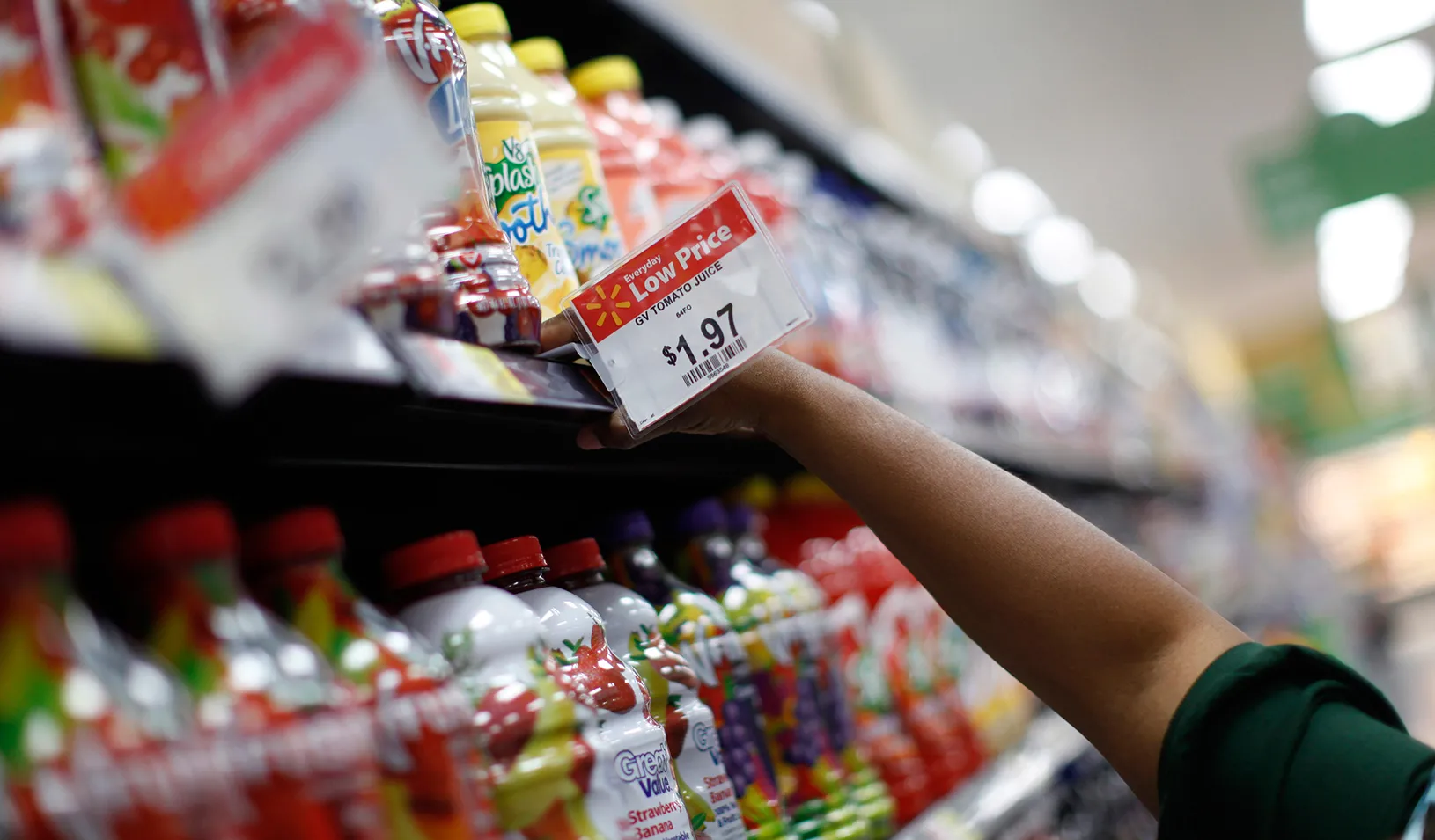 A Walmart juice shelf price sign