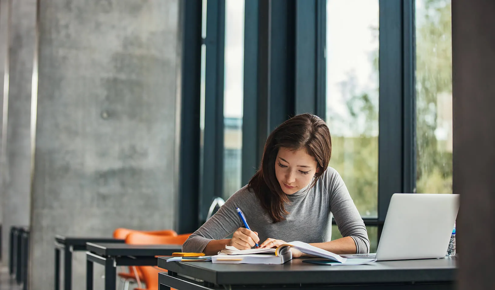 Girl studying in a library | iStock/Jacob Ammentorp Lund