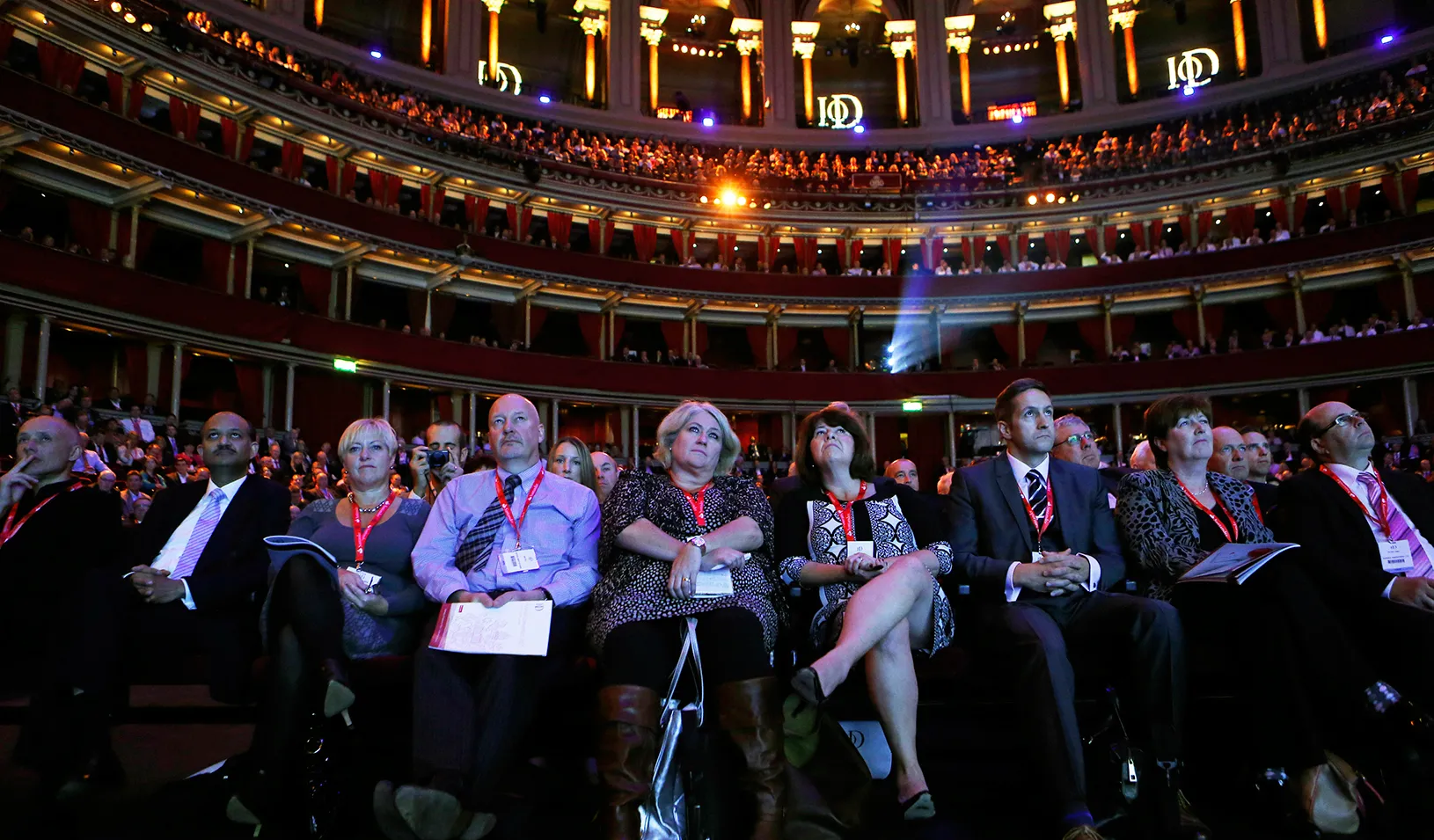 Members of the audience listen as Britain's Chancellor of the Exchequer George Osborne speaks at the Institute of Directors annual convention in London September 18, 2013.