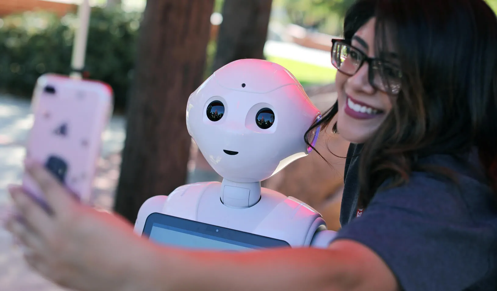 San Marcos student Amaris Gonzalez takes a selfie with "Pepper" an artificial Intelligence project utilizing a humanoid robot. | Reuters/Mike Blake