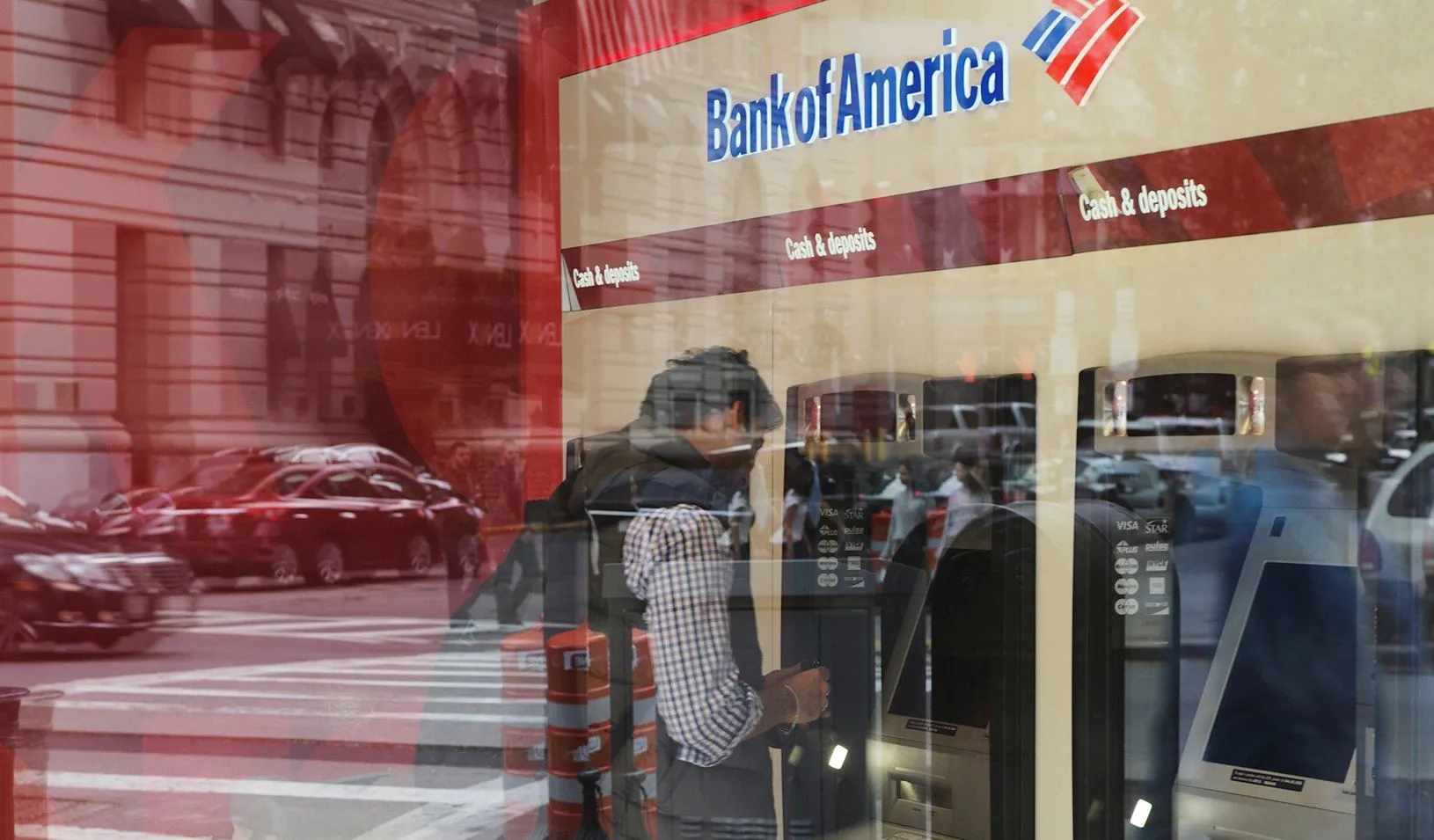 A customer uses an ATM at a Bank of America branch. Credit: REUTERS/Brian Snyder