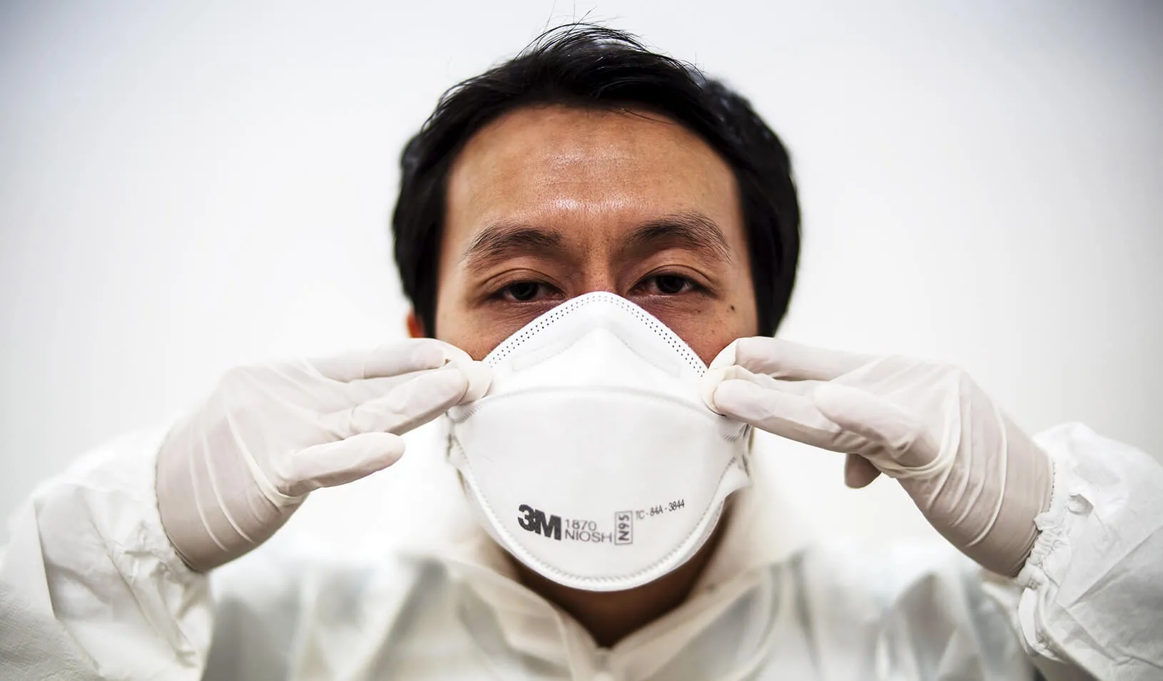 A doctor puts on his medical mask | Reuters/Athit Perawongmetha