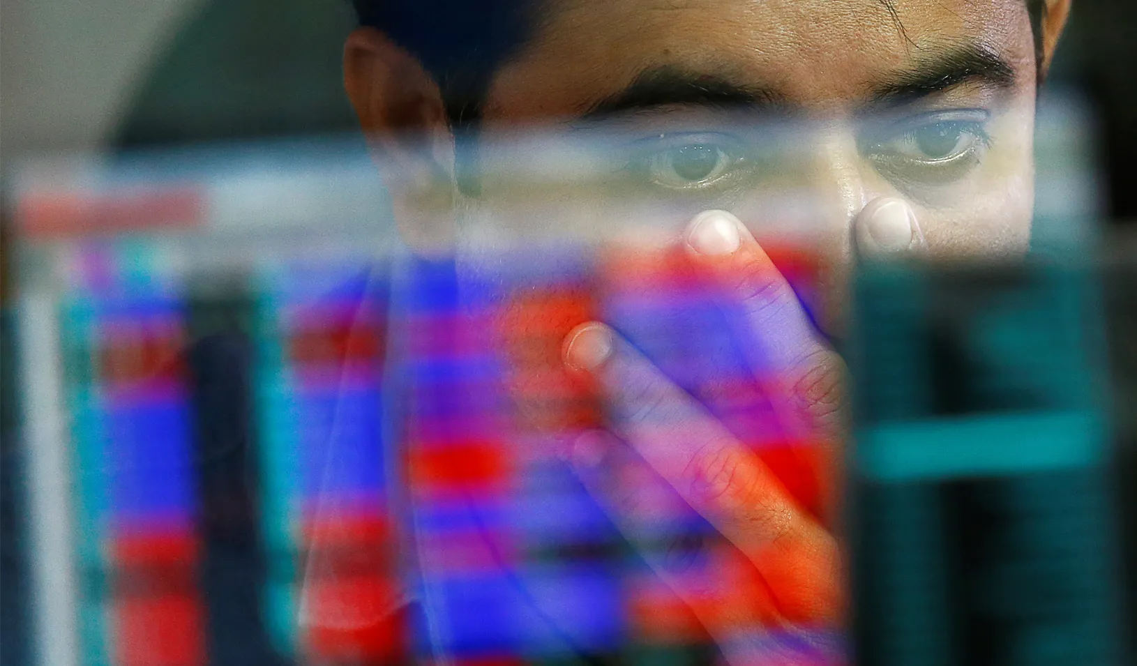 A broker reacts while trading at his computer terminal at a stock brokerage firm in Mumbai, India. Credit: REUTERS/Danish Siddiqui