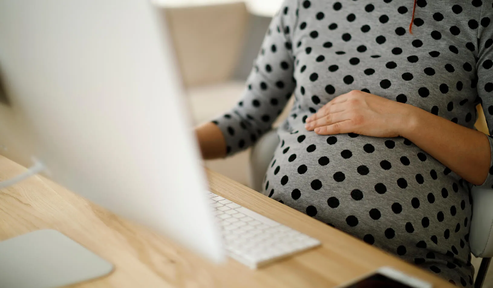 Pregnant woman working from home office stock photo. Credit:iStock/damircudic