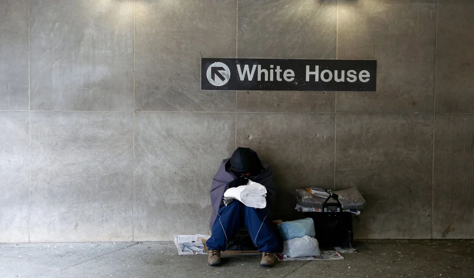 A homeless person tries to stay warm at the entrance of a subway station near the White House. Credit: Reuters/Kevin Lamarque