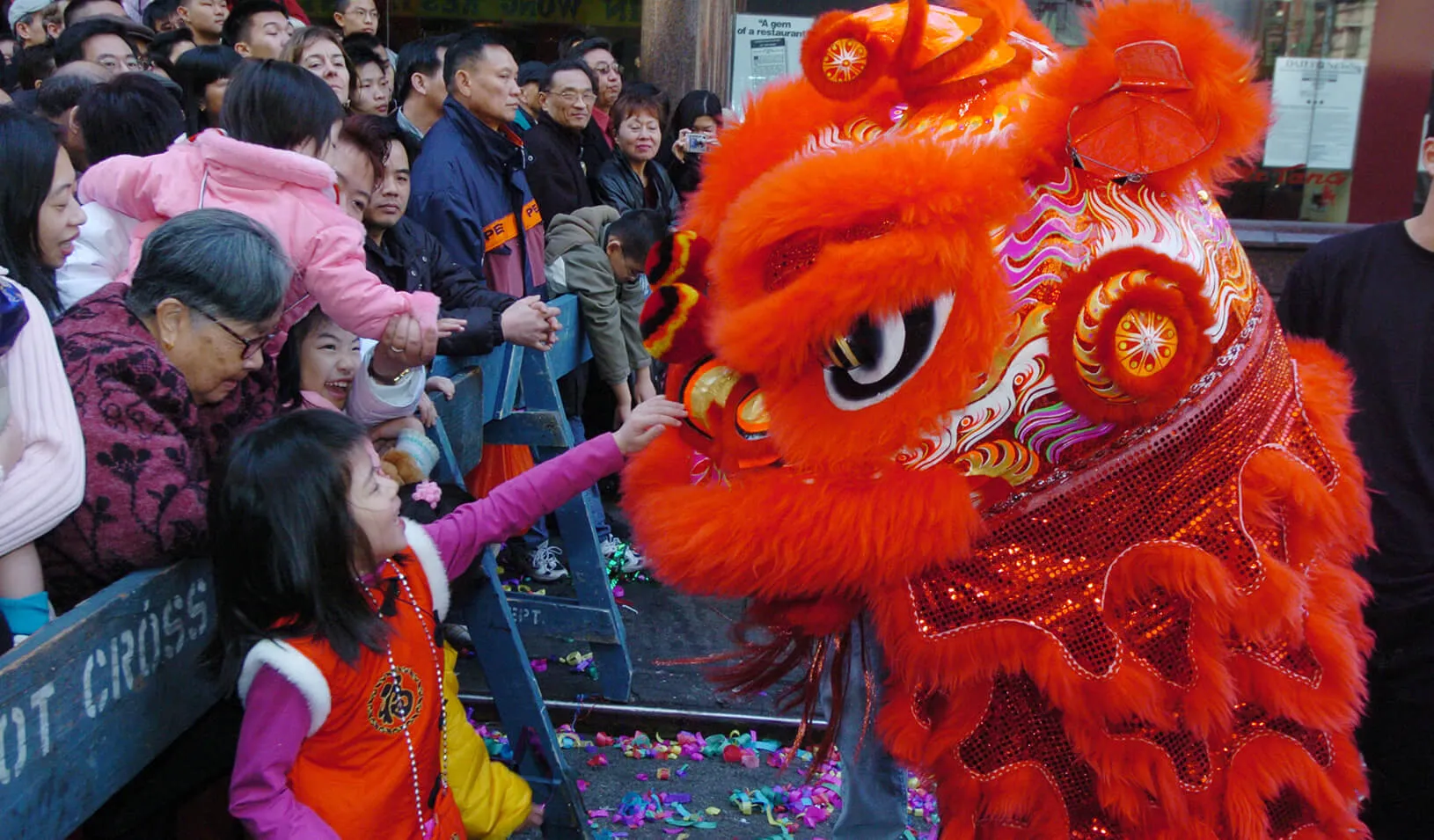 Children reach to touch the dragons taking part in Lunar New Year celebrations in New York's Chinatown section. It is believed that feeding the dragon a lucky red envelope, or patting it on the head, brings good fortune. Credit: Reuters/Henny Ray Adams