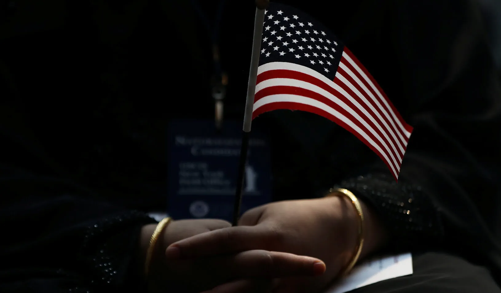  An immigrant woman holds a U.S. flag during a U.S. Citizenship and Immigration Services Naturalization ceremony in the New York Public Library in New York.  Credit: REUTERS/Shannon Stapleton