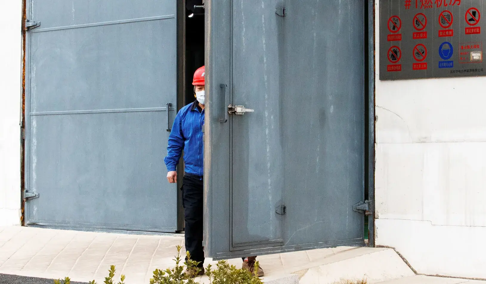 A worker wearing a face mask is seen at a plant in Beijing as the country is hit by an outbreak of the novel coronavirus. Credit: REUTERS/Thomas Peter