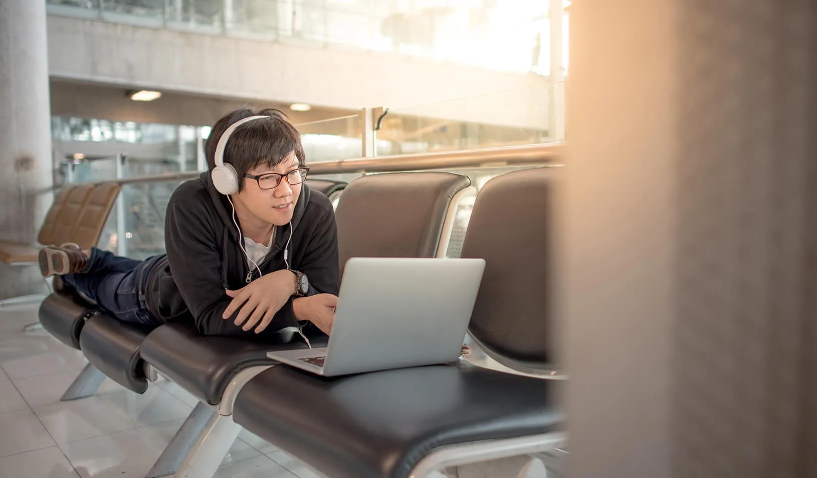  man watching a video on his laptop | iStock/Zephyr18