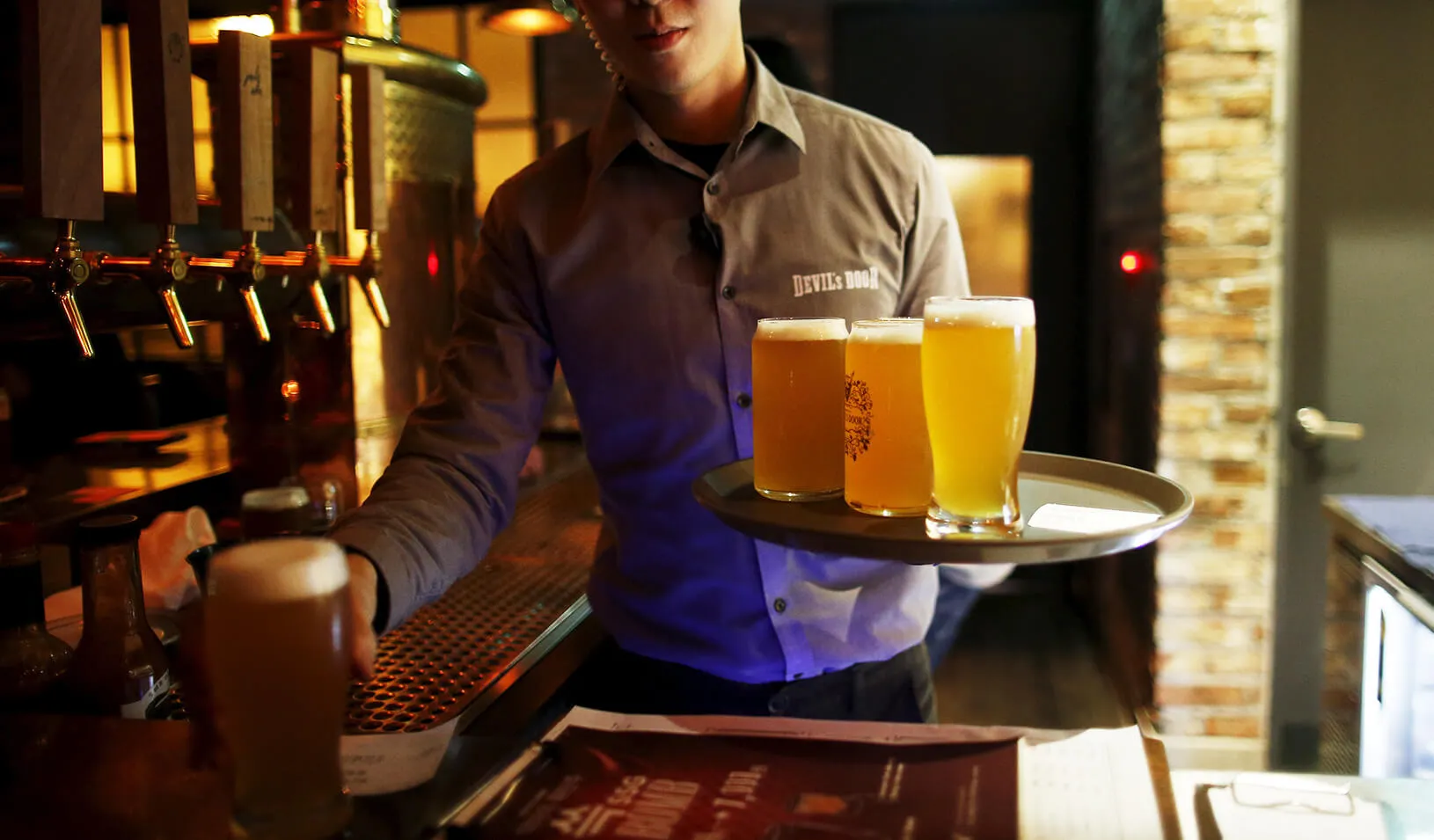 man serving craft beer