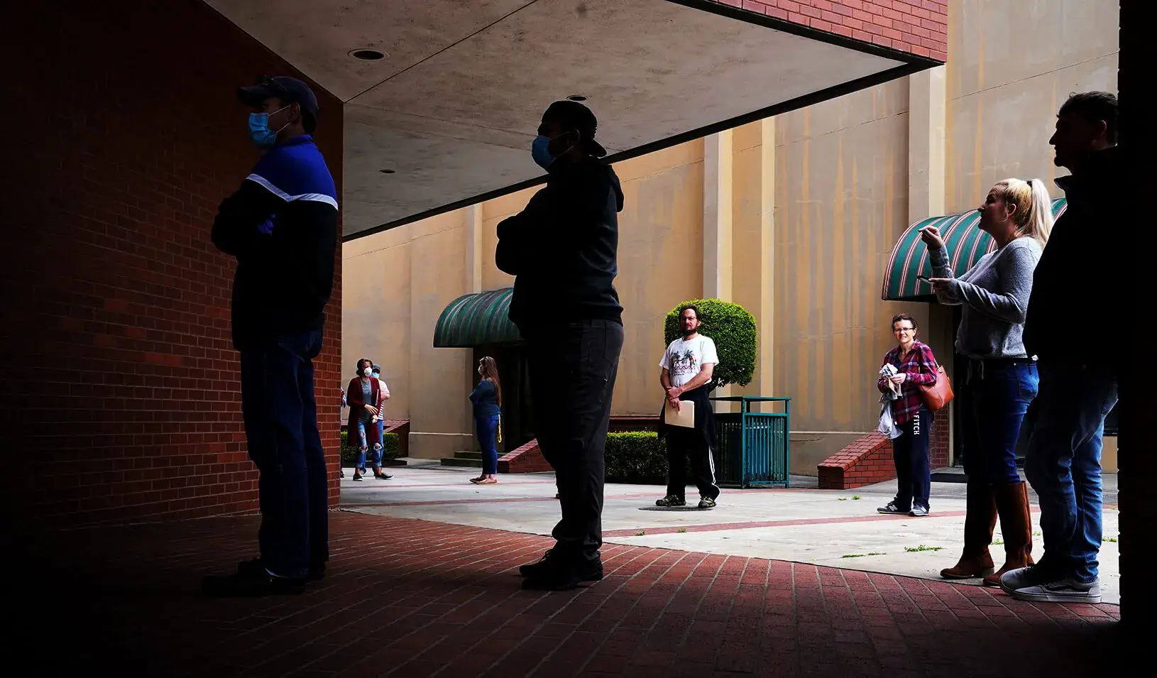 People who lost their jobs wait in line to file for unemployment following an outbreak of the coronavirus disease (COVID-19) at an Arkansas Workforce Center. Credit: Reuters/Nick Oxford